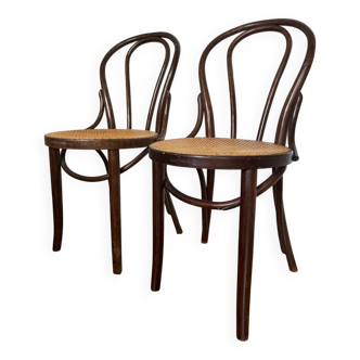 Pair of wooden bistro chairs with caning