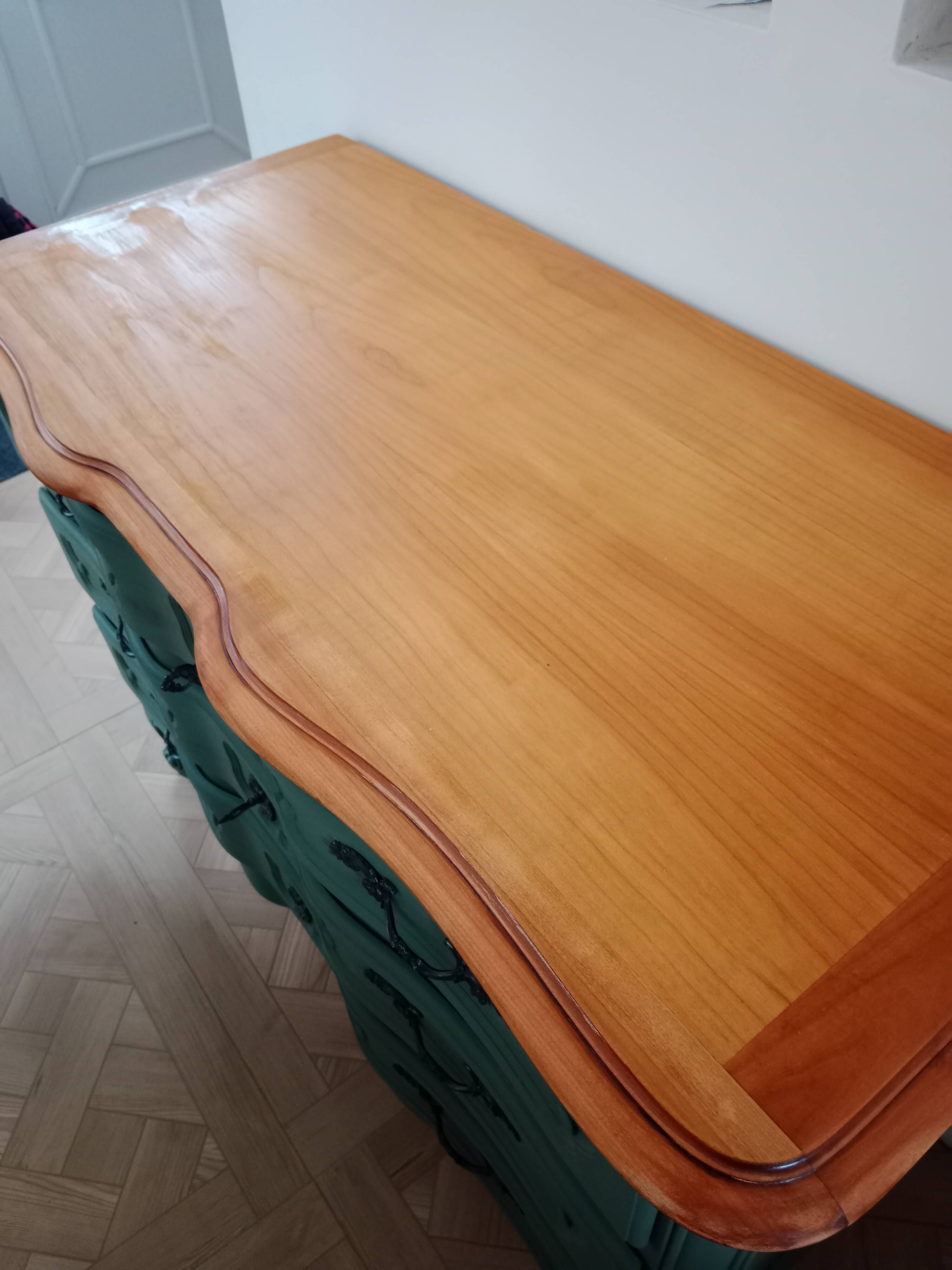 Dark green patina crossbow chest of drawers