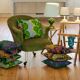 Toad in almond green velvet armchair on castors