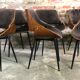 Scandinavian style chairs in curved plywood covered with brown fabric