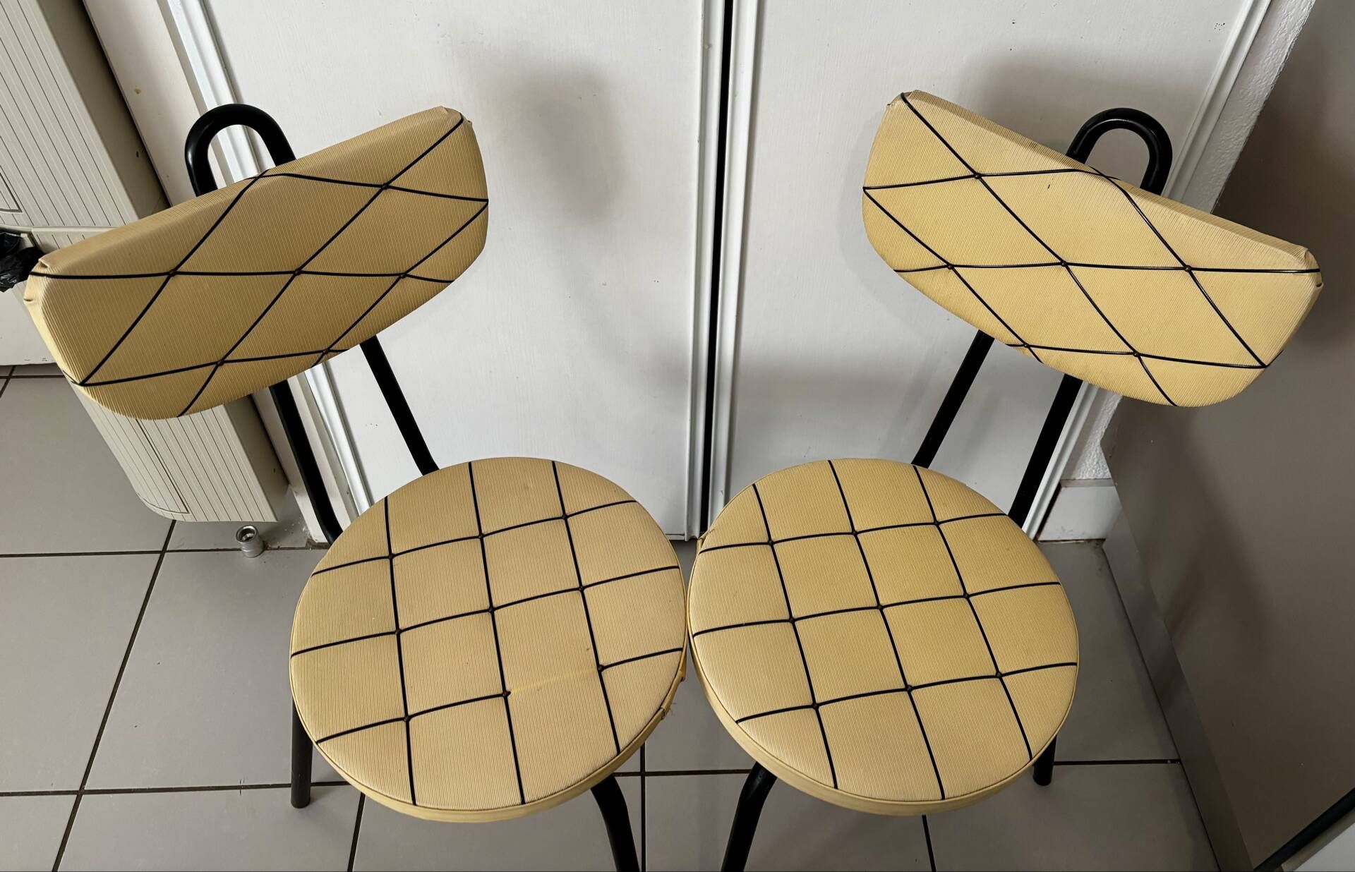 Pair of vintage retro mustard yellow chairs with black metal.