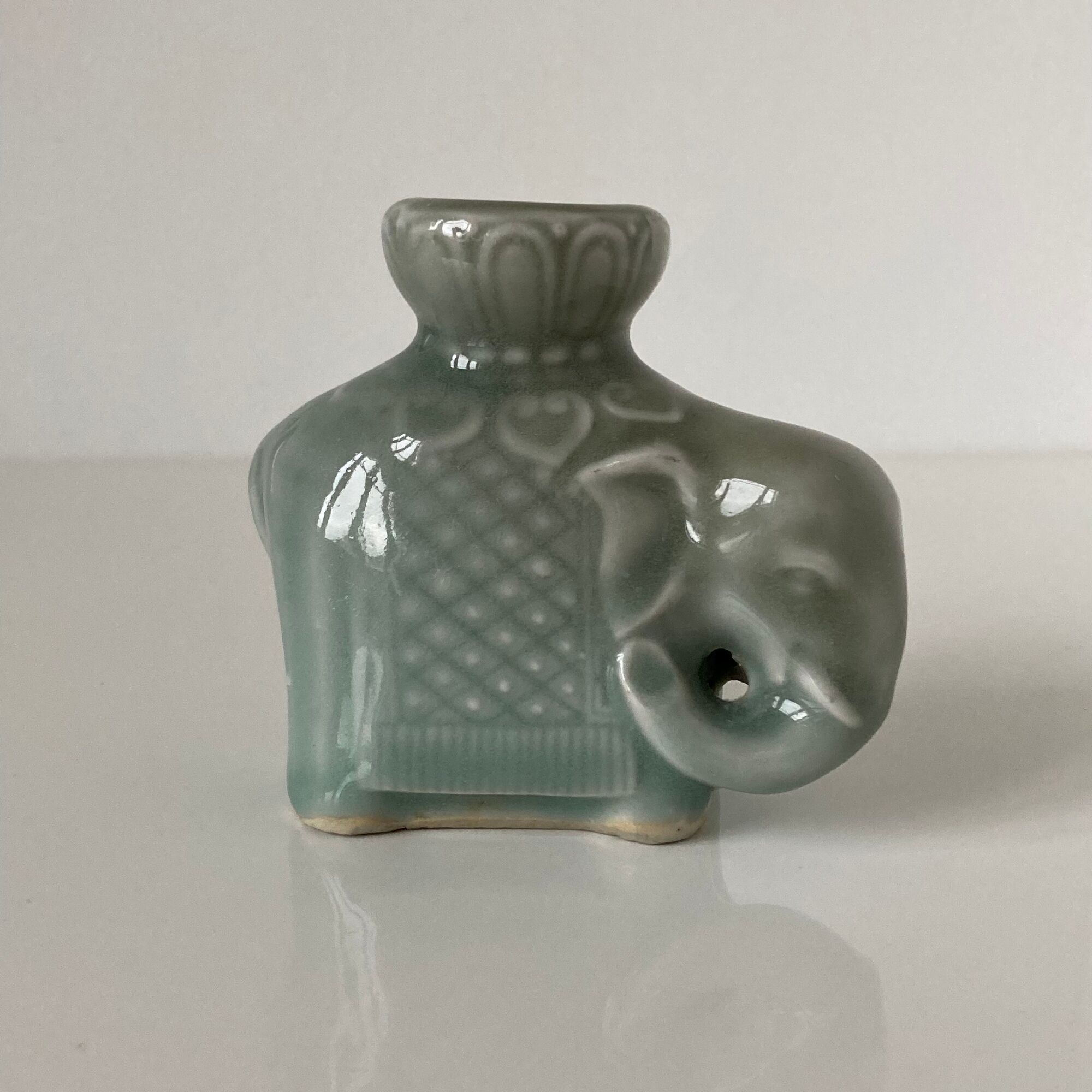 Porcelain candle holder and celadon cover in the shape of an elephant
