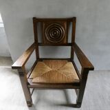 Armchair in carved solid wood with straw seat