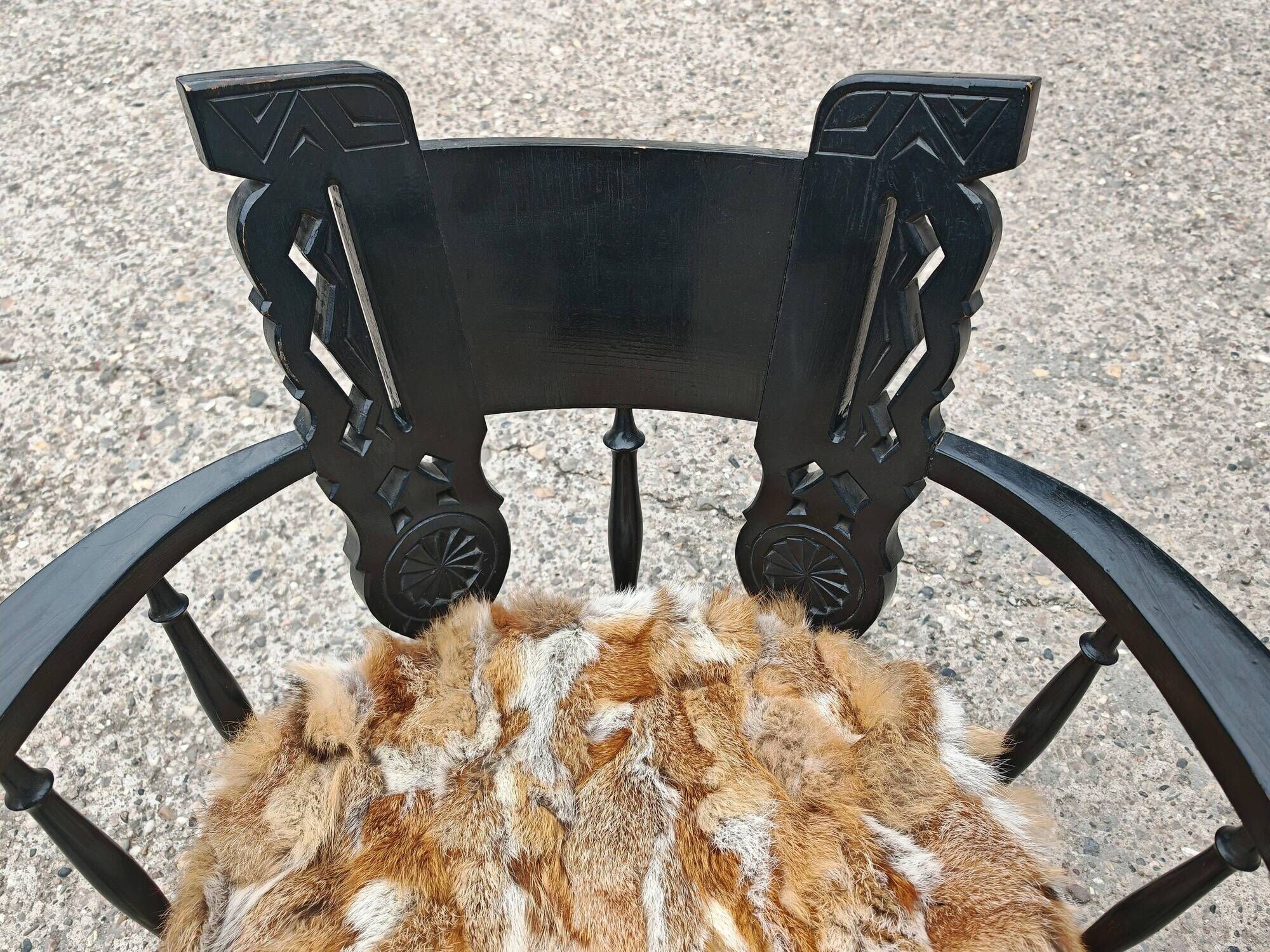 Pair of hand-carved armchairs in black lacquer and fur, 1920s.