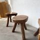 Set of three rustic solid wood tripod stools.