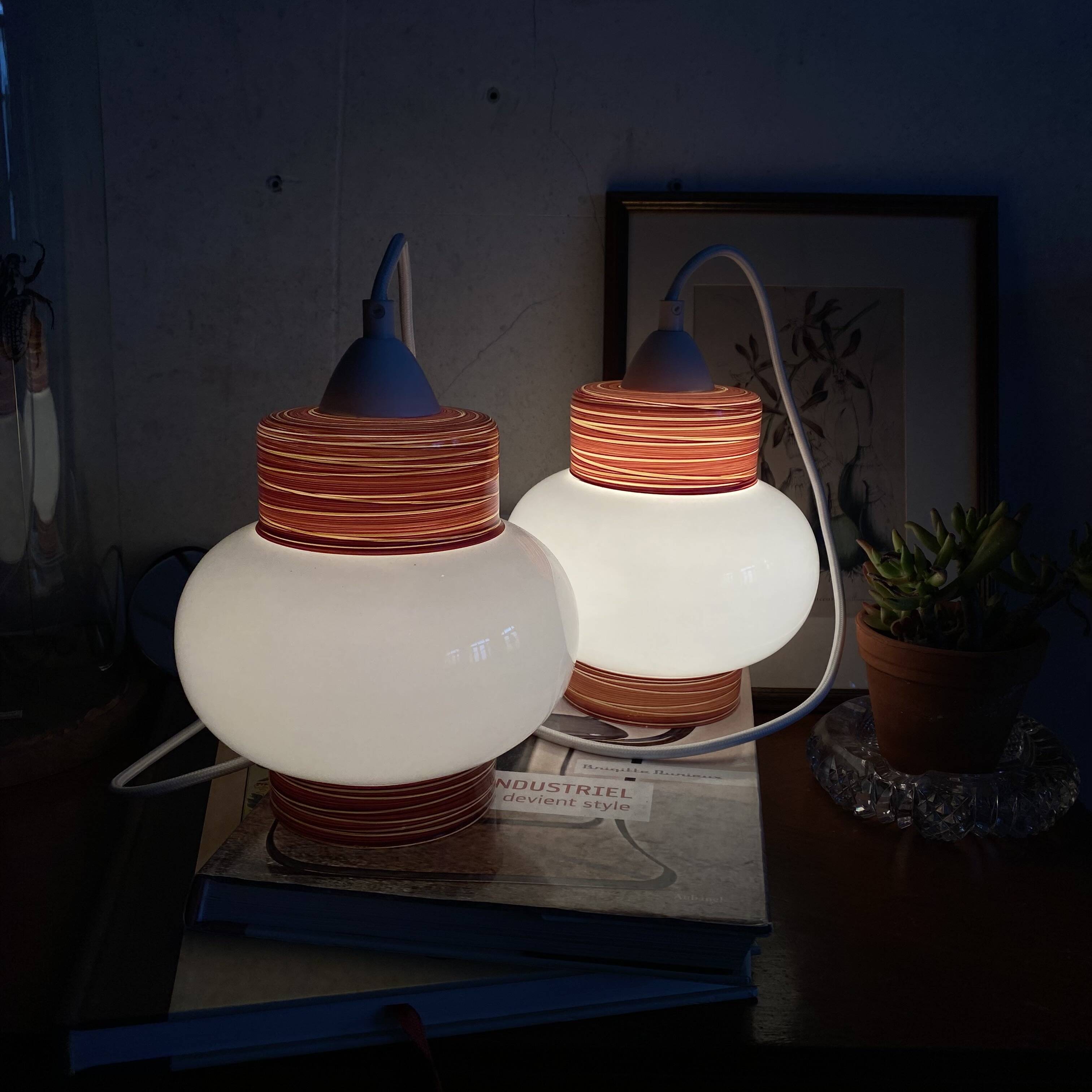 Pair of pendant lights with white glass shades from the 1950s.