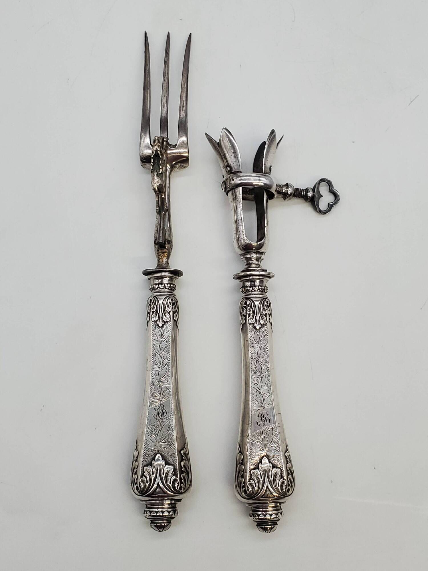 Set of serving forks and silver-plated leg of lamb fork.