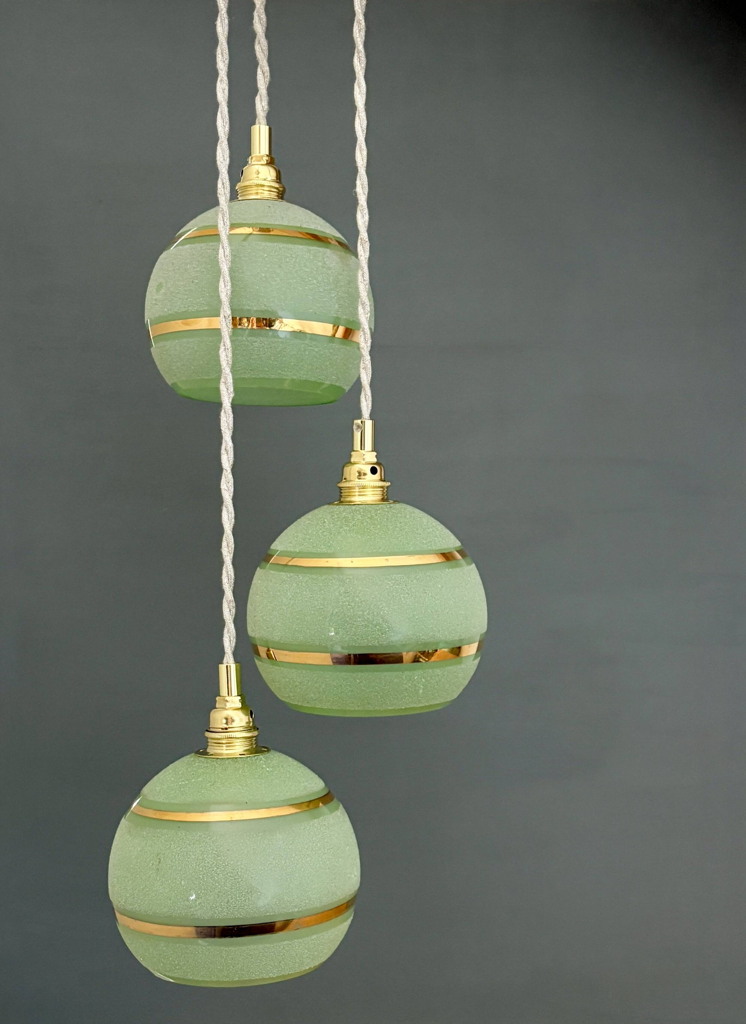 Suspension triple vintage glass globes in frosted green and gold.