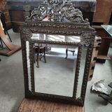 Mirror with embossed brass bead