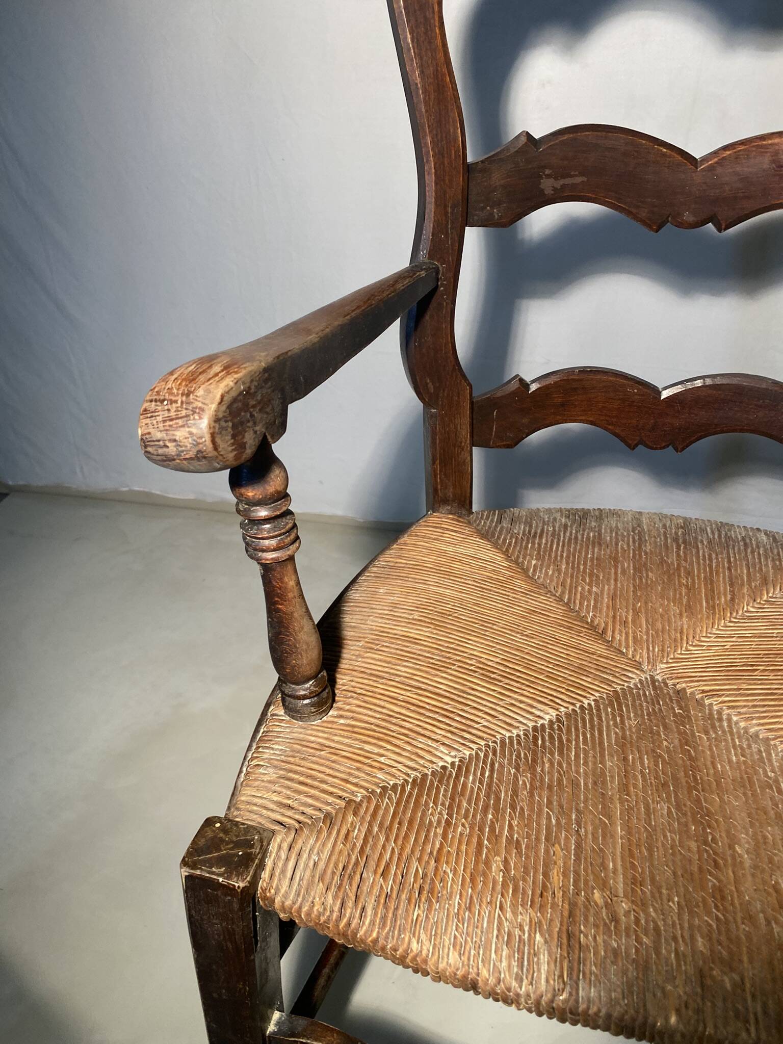 Antique Provencal armchair in carved wood with straw seat