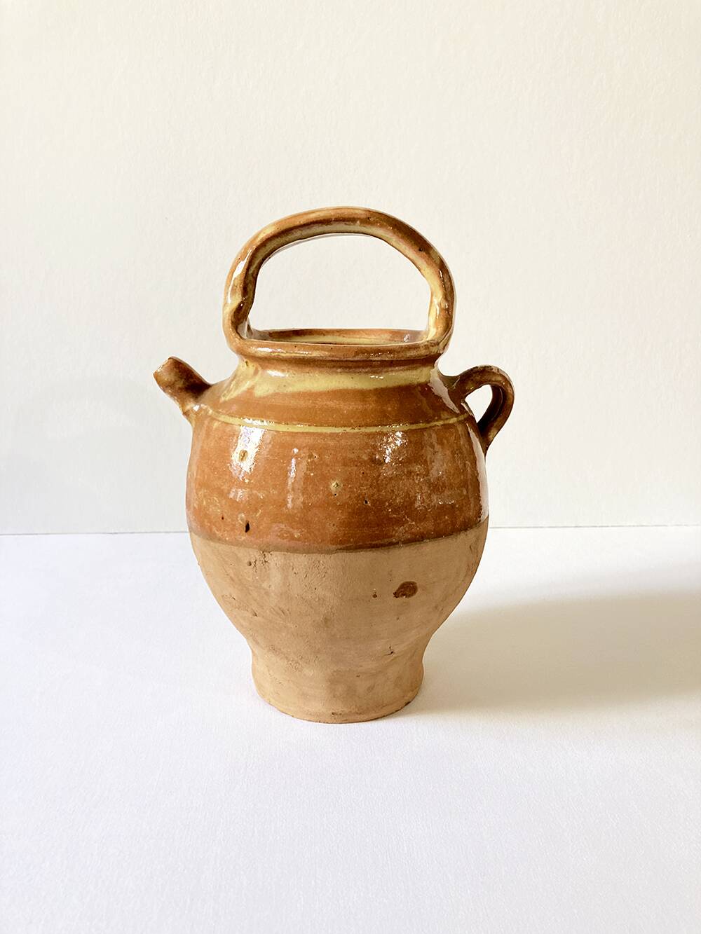Old ochre and yellow glazed ceramic jug / goat