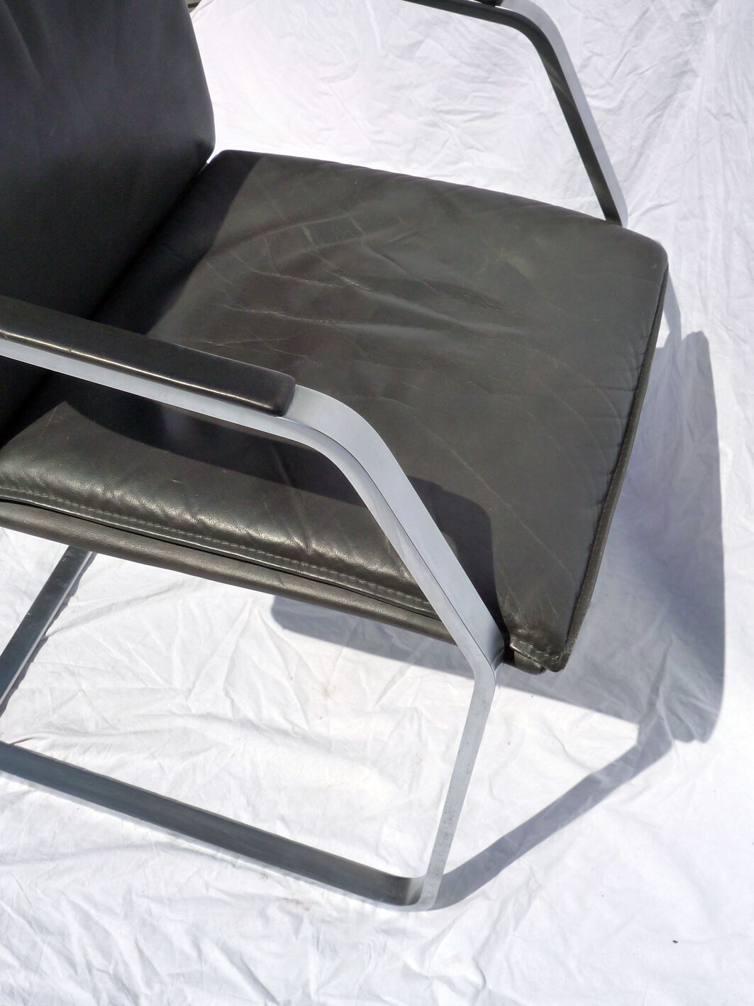 Chair with steel and leather armrests
