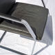 Chair with steel and leather armrests