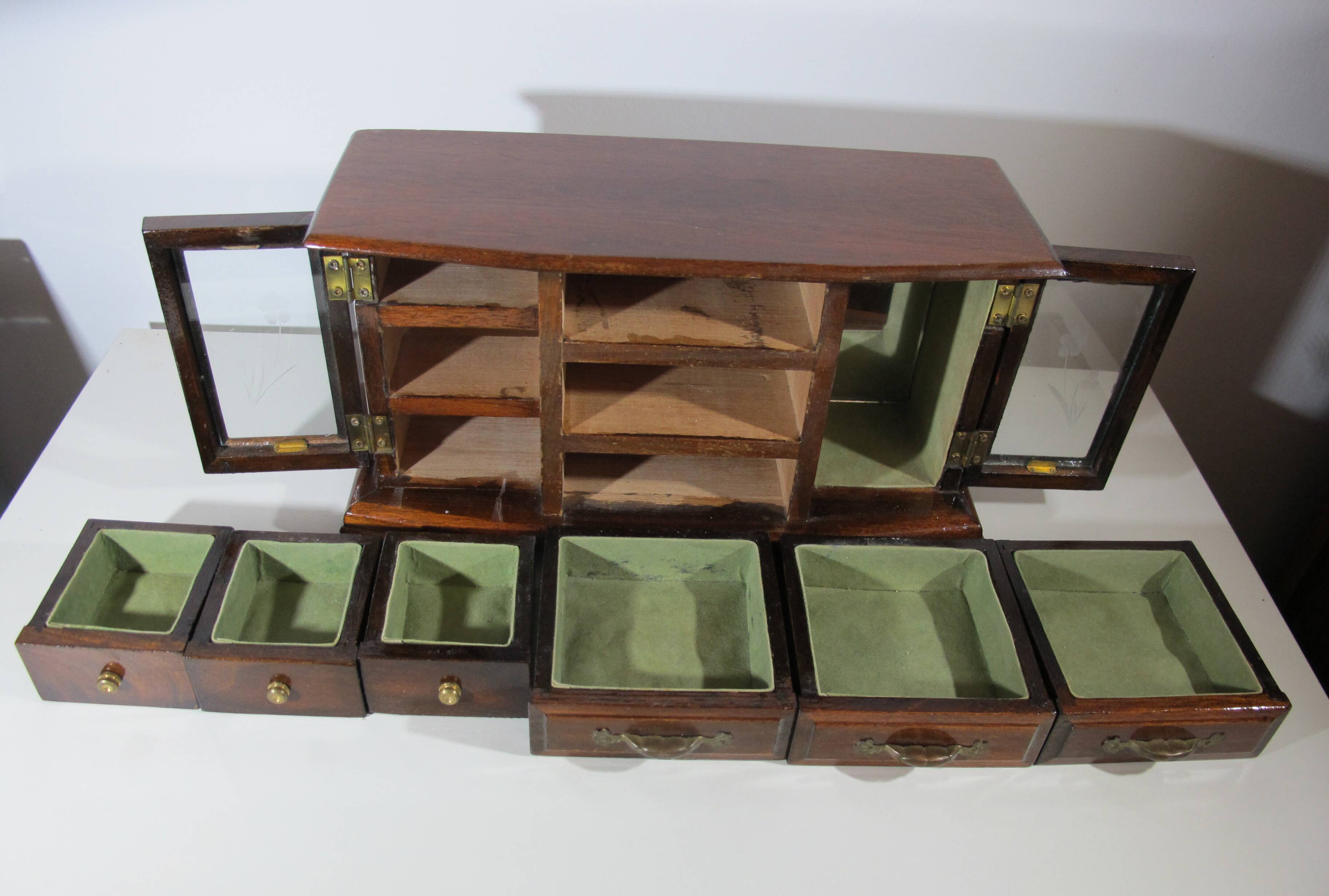 Wooden jewelry box in the shape of a dresser