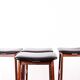 4 Danish high stools, rosewood and black leather, Knud Bent for Dyrlund.