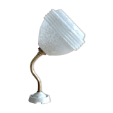 White Clichy glass globe wall light, porcelain support and gooseneck stem in brass