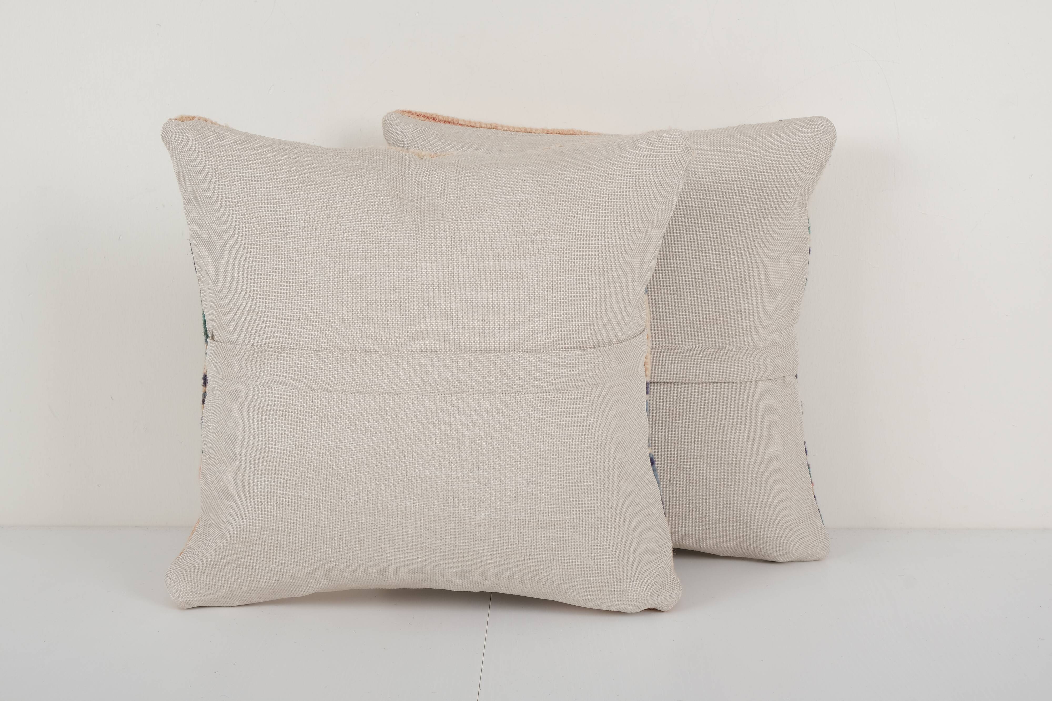 Set of two muted ecru carpet rug pillows