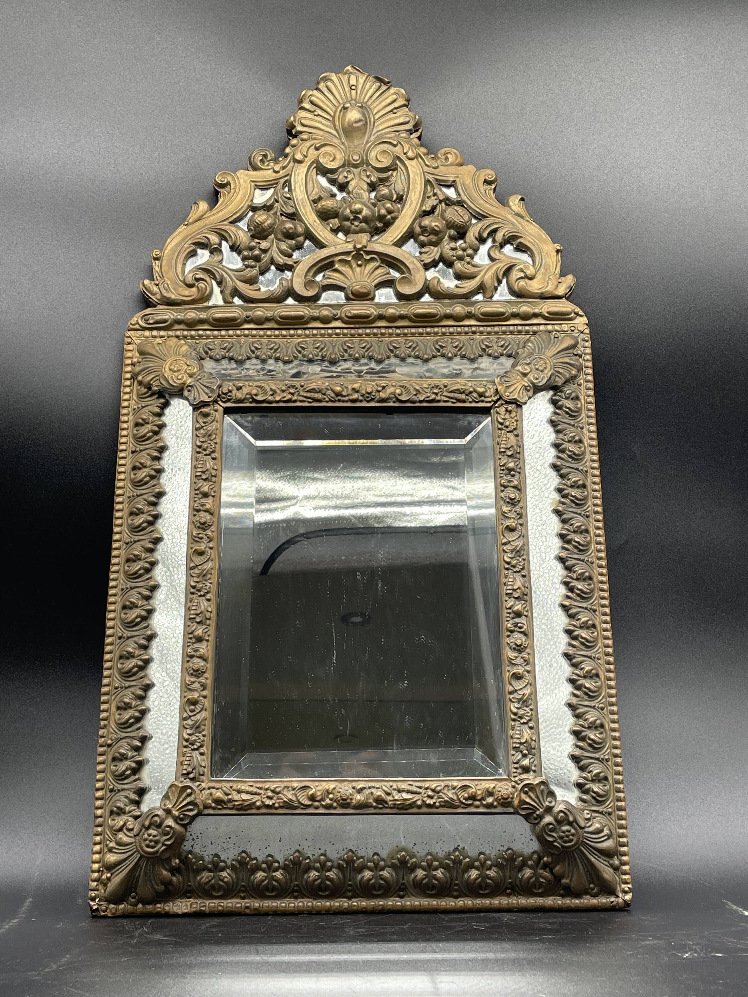 Small mirror with brass parcloses in repoussé style Louis XIV, late 19th century.
