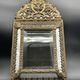 Small mirror with brass parcloses in repoussé style Louis XIV, late 19th century.