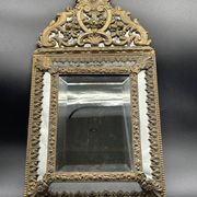 Small mirror with brass parcloses in repoussé style Louis XIV, late 19th century.