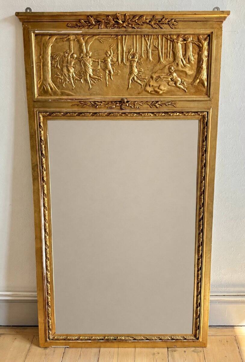 Gilded trumeau in the Louis XVI style with curious decorations.