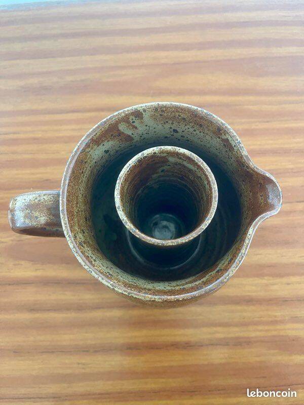 Large antique brown glazed stoneware jug with cork stopper.