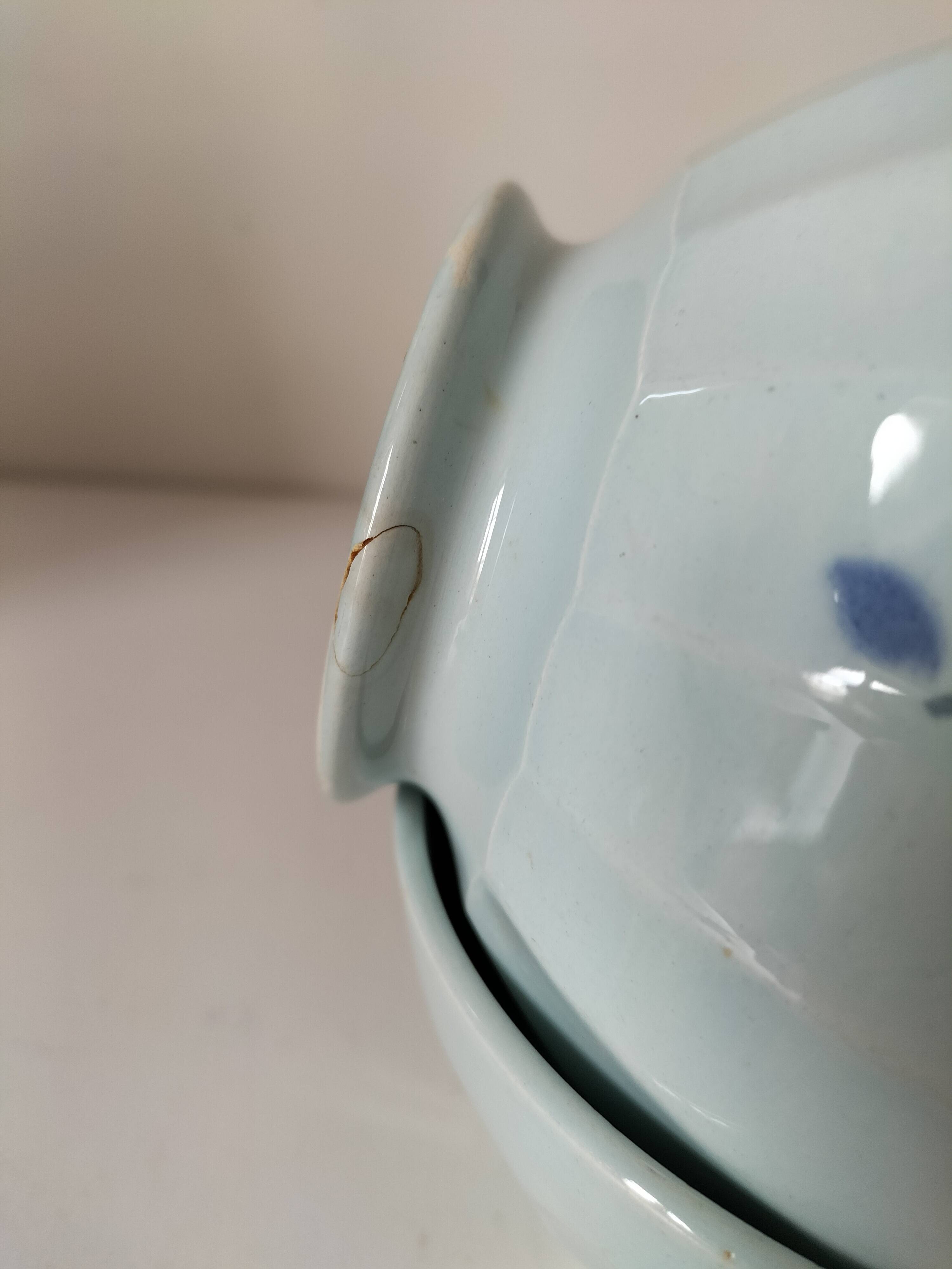 Two vintage farm bowls on a pale blue pedestal with floral decoration.