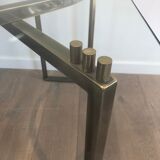 Console en acier brossé et laiton et plateau formé d'une dalle de verre. Travail français. Vers 1970