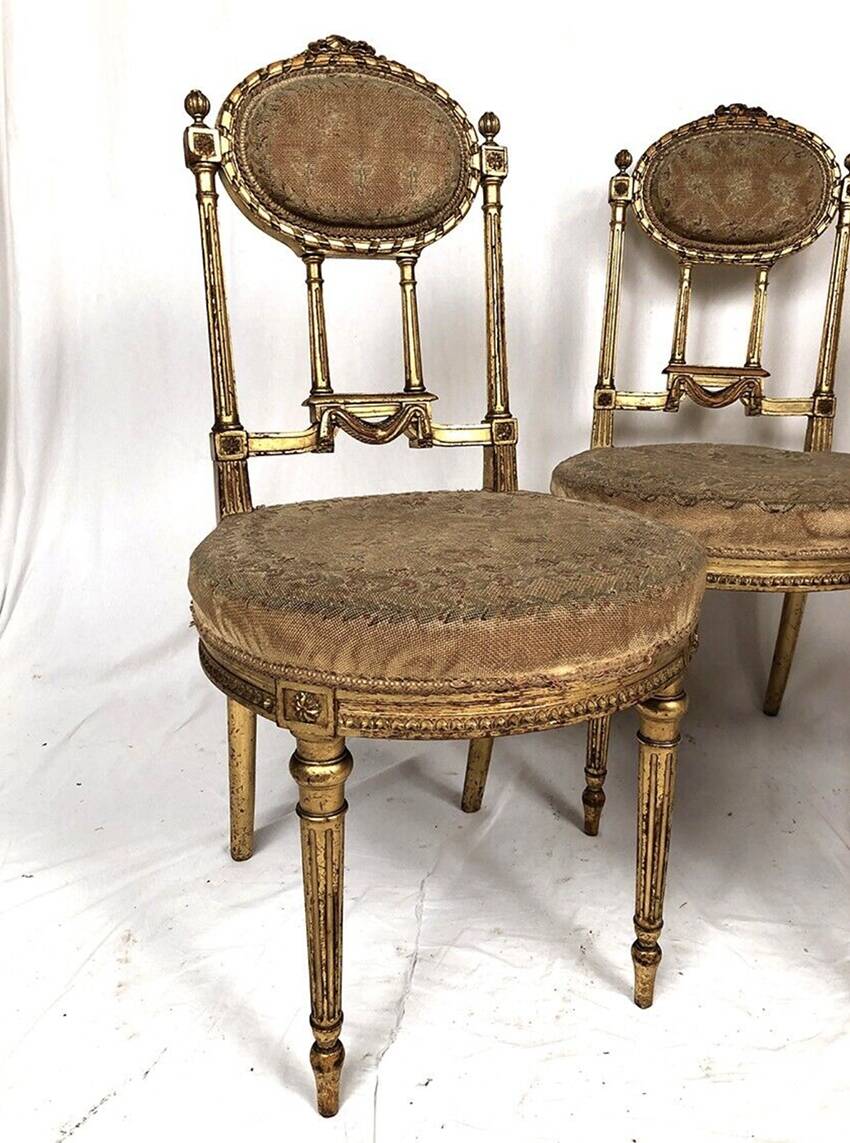 Series of three Louis XVI style chairs in gilded wood, circa 1900