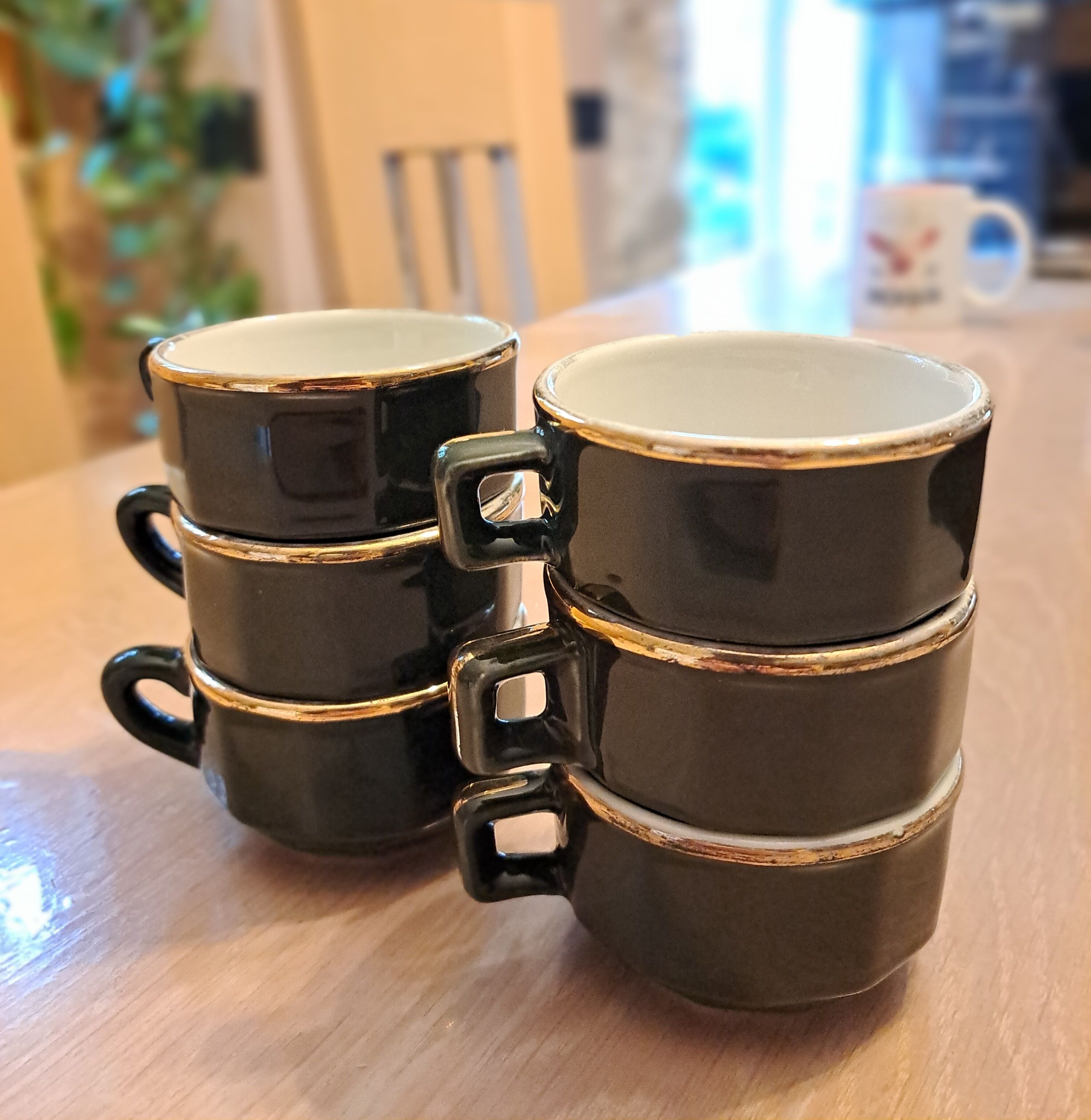 Green and gold coffee cups and sub-cups