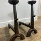 Pair of antique cast iron fire dogs, rustic decor, around 1900.