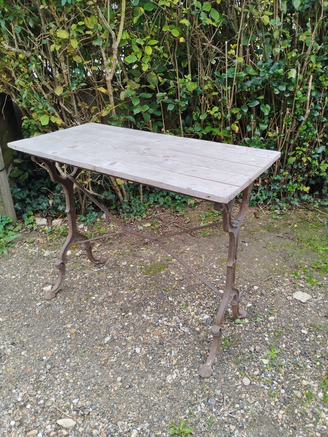 Antique bistro table with iron legs and wooden top