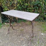 Antique bistro table with iron legs and wooden top