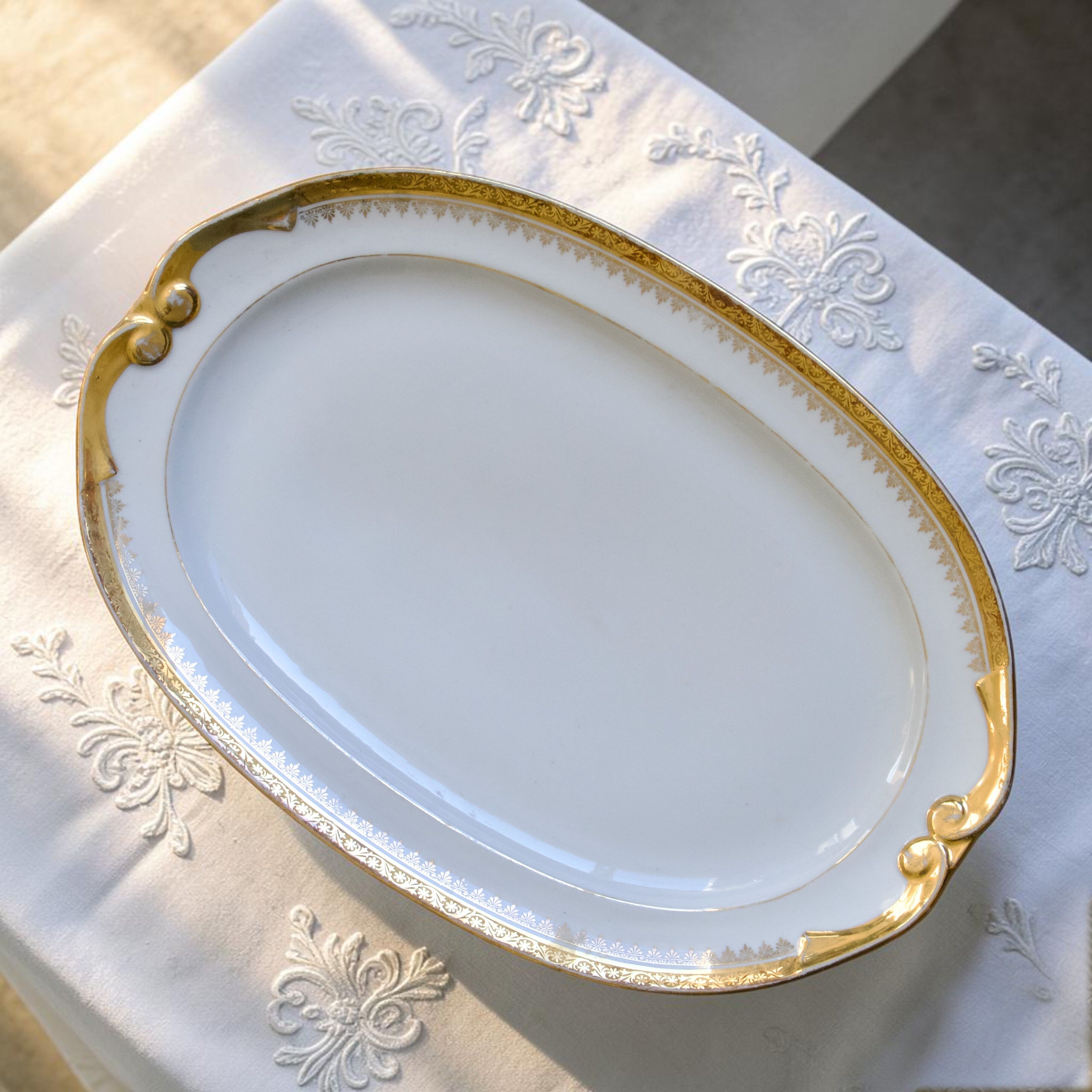 Large oval dish with gold trim in Limoges porcelain by Peconnet.