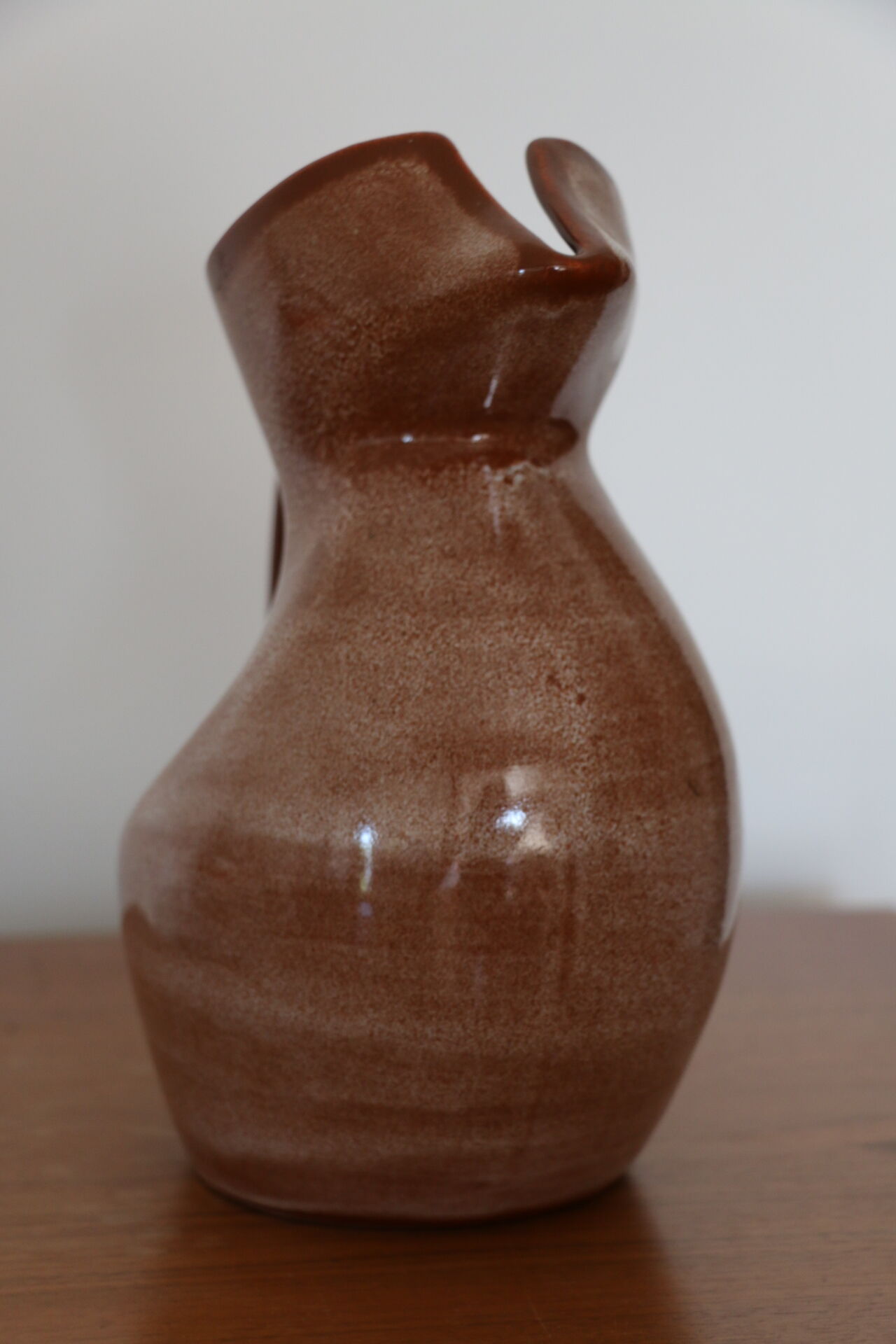 Brown painted earthenware pitcher