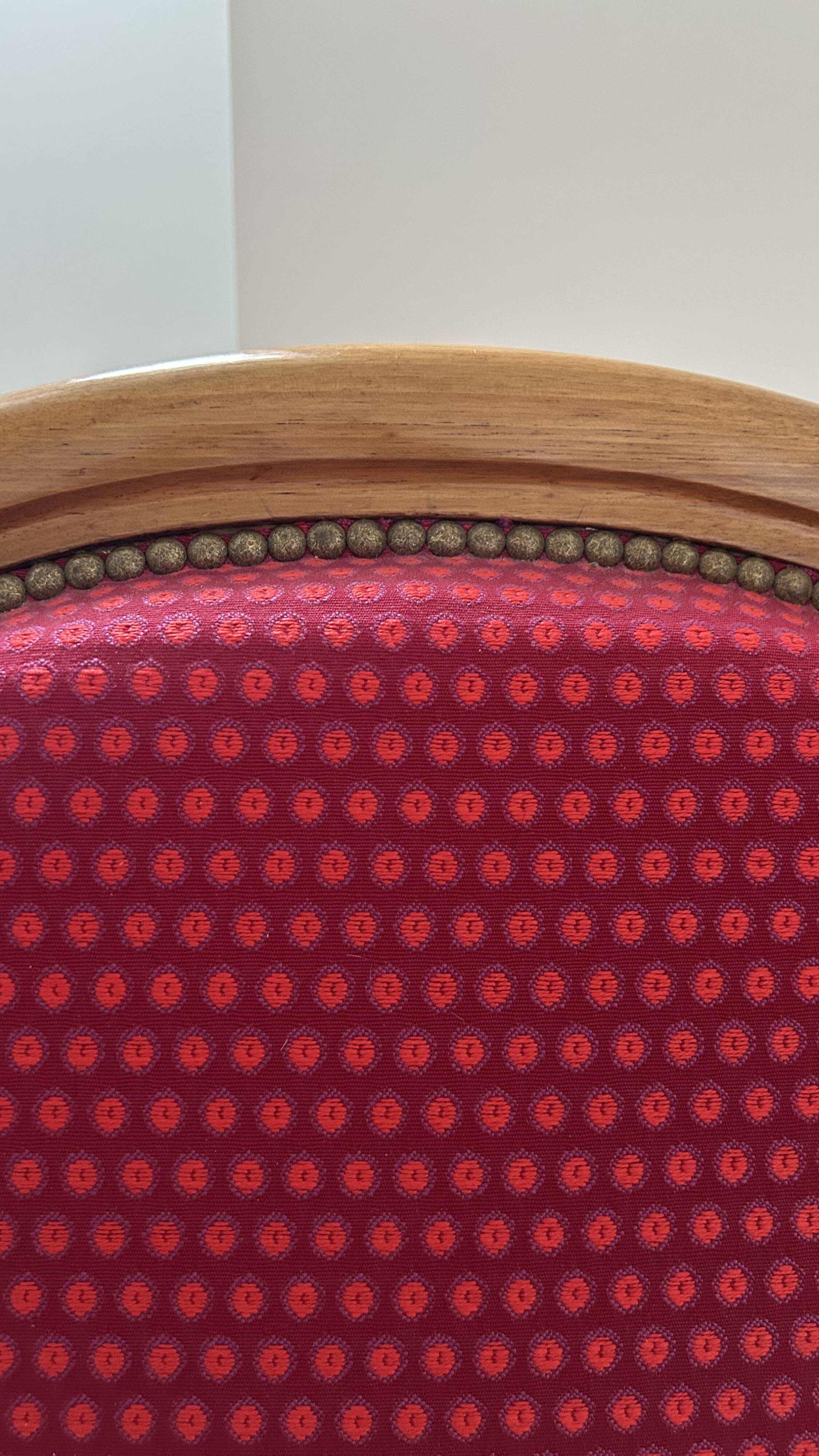 Antique Louis Philippe armchair in walnut and red fabric.