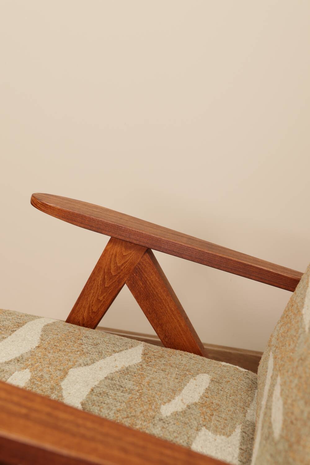 Pair of vintage lounge chairs in brown jacquard fabric and wood.