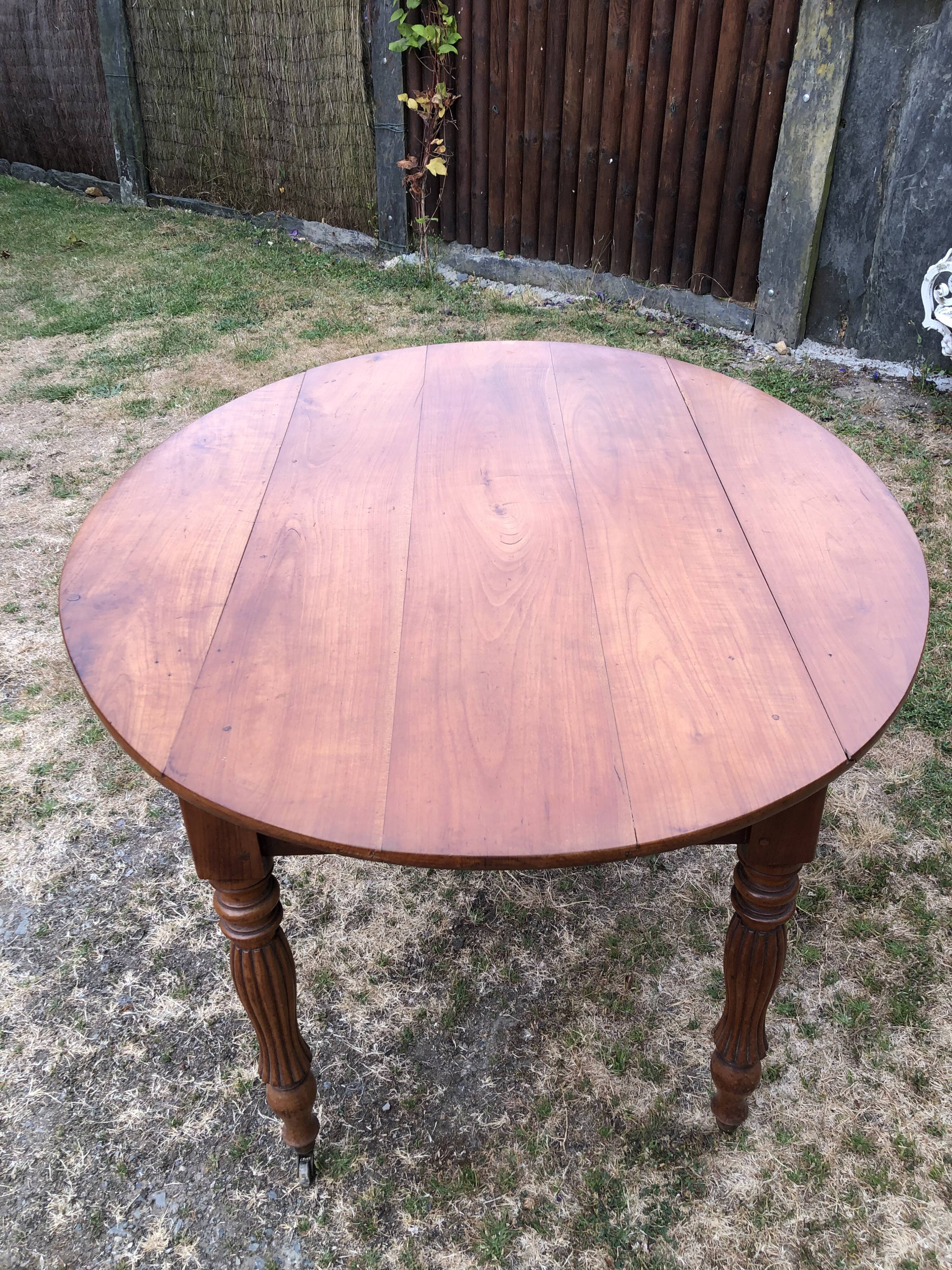 Louis Philippe oval drop-leaf table in solid cherry wood with 2 drawers.