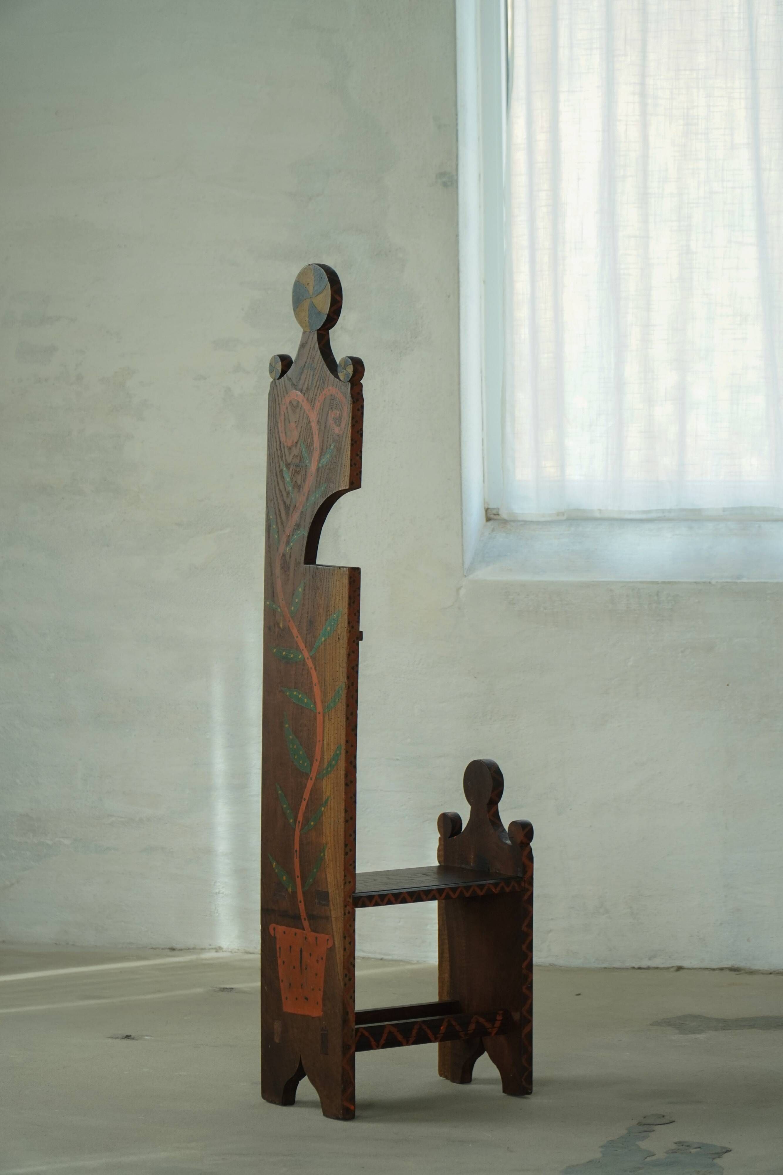 Danish popular art chair with a high back, made of oak, featuring hand-painted decoration, dated 1876.