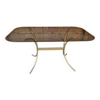 1970s dining table in gilded brass and smoked glass, Hollywood Regency style.
