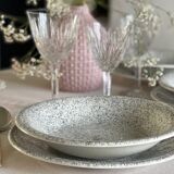 12 speckled ceramic plates.