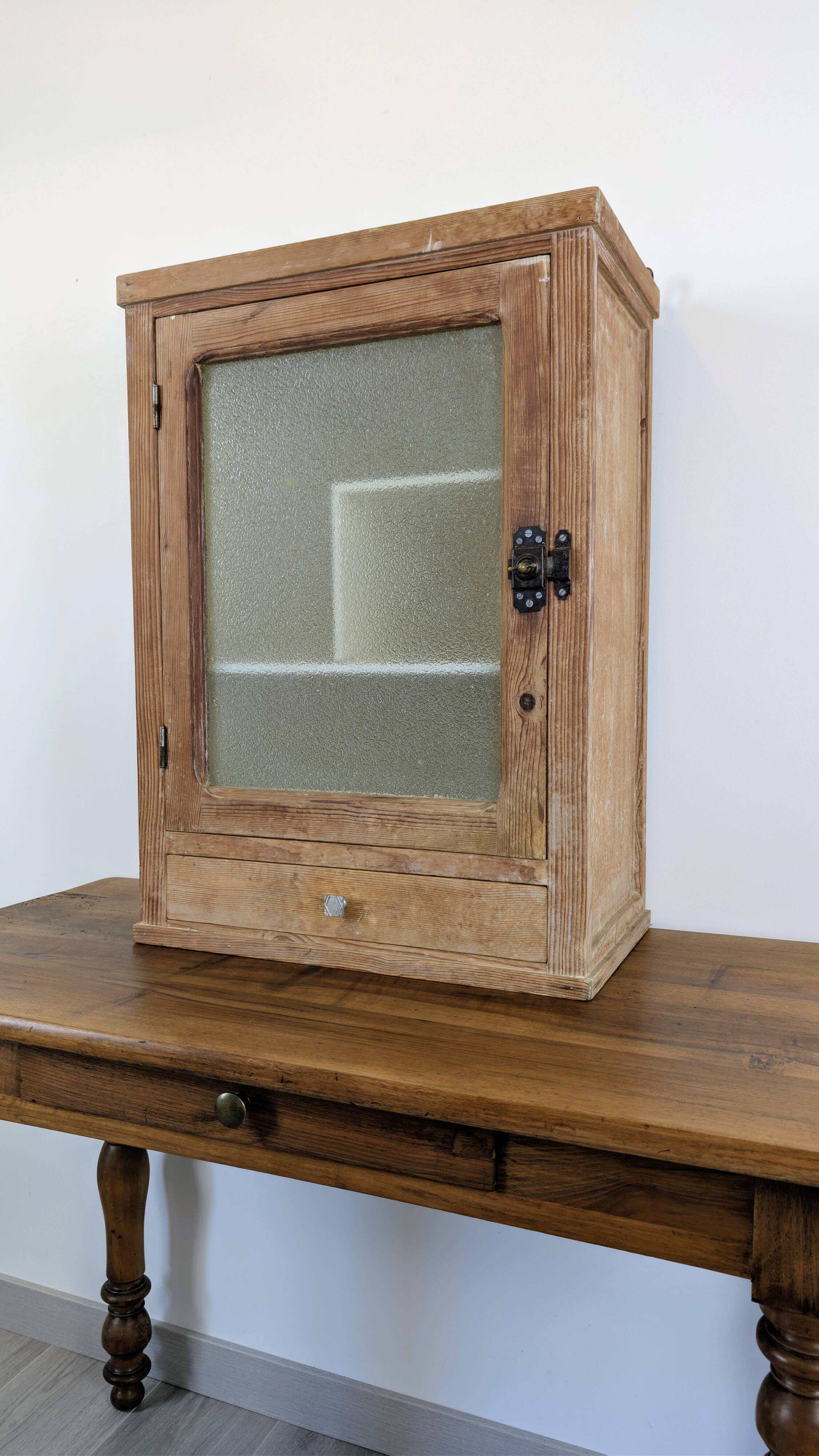 Small glass wall cabinet from the 1960s.