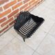 Old cast iron log cradle with backrest