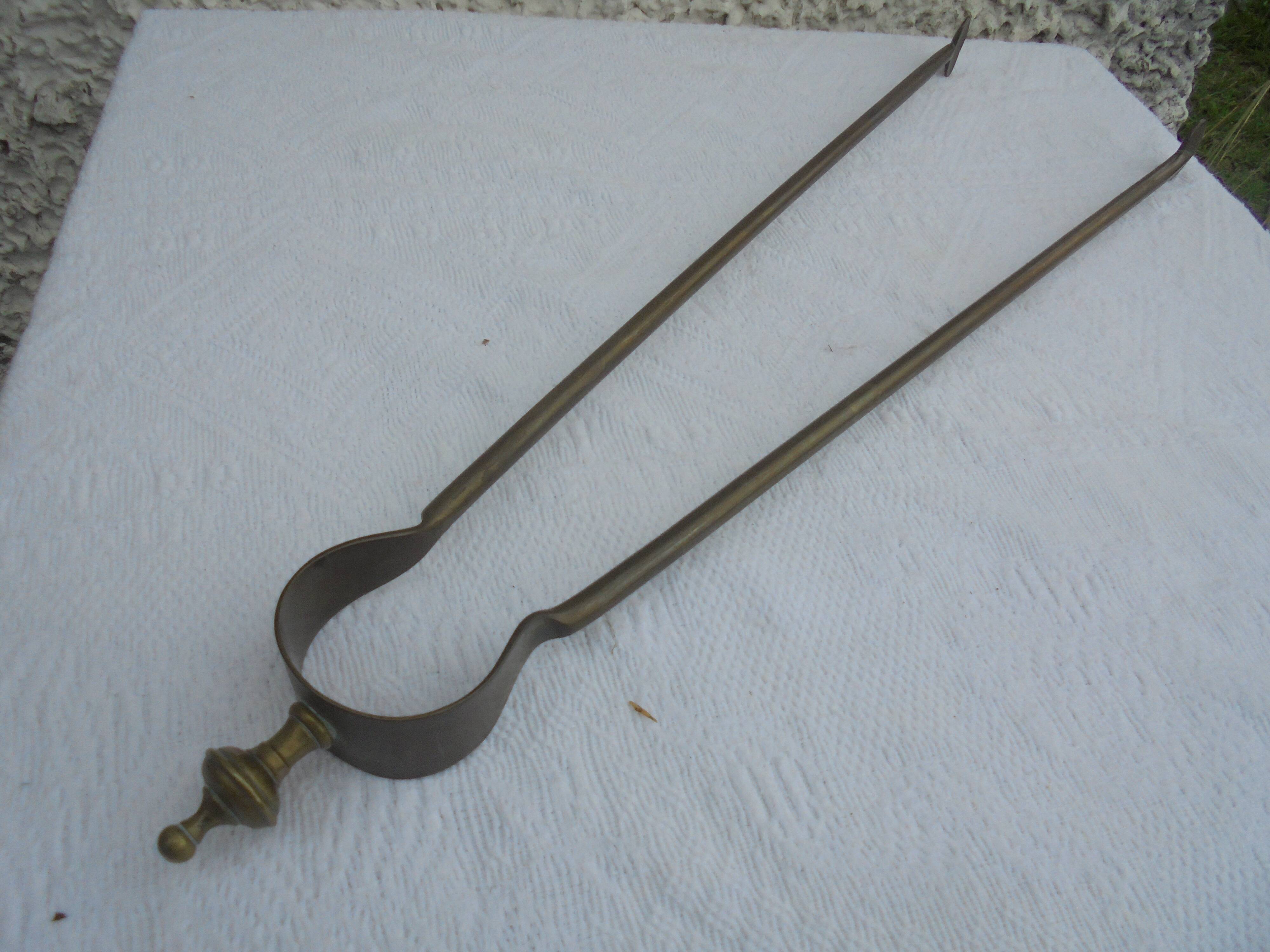 Old brass log clamp for fireplace