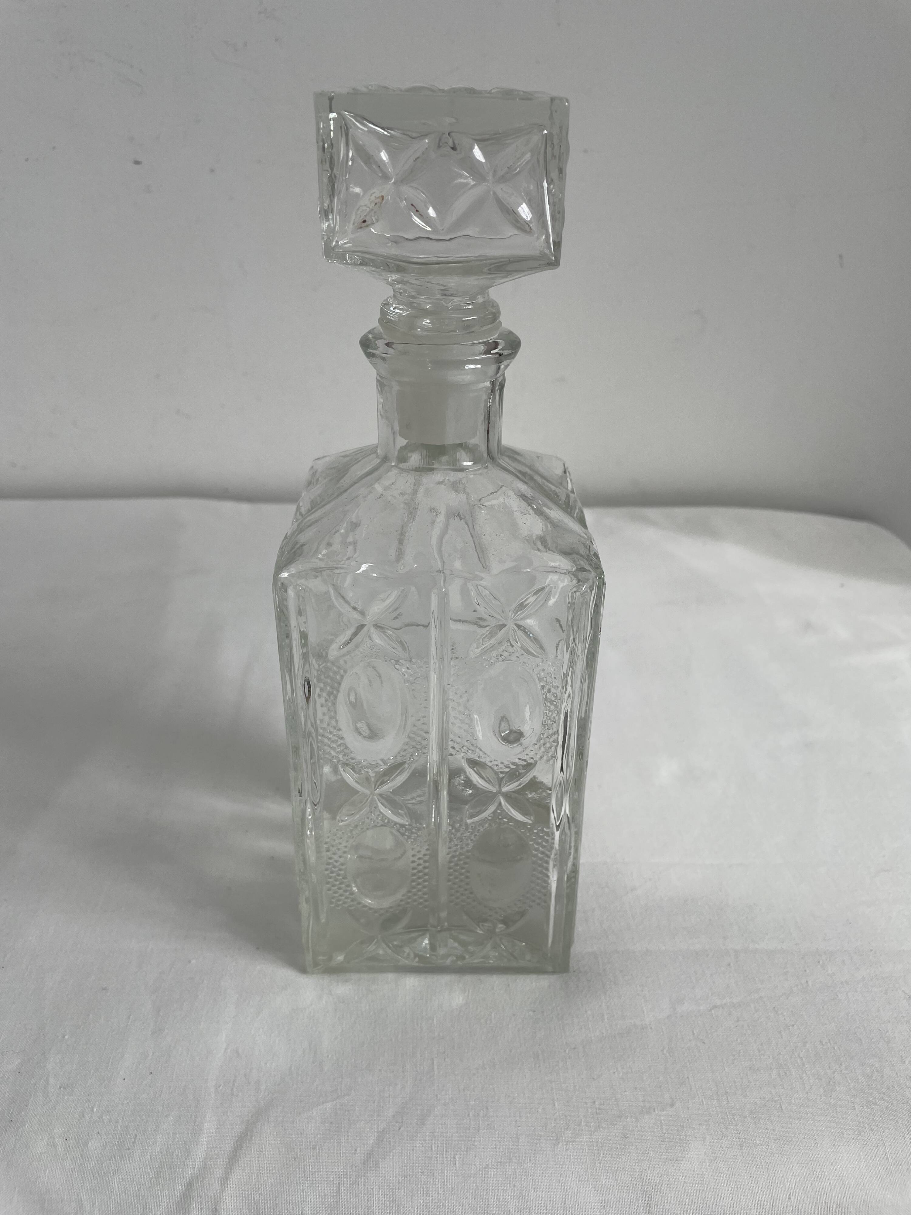 Molded glass carafe, 1960s-1970s, stylized flower decoration, oval, square base, stopper, rosette