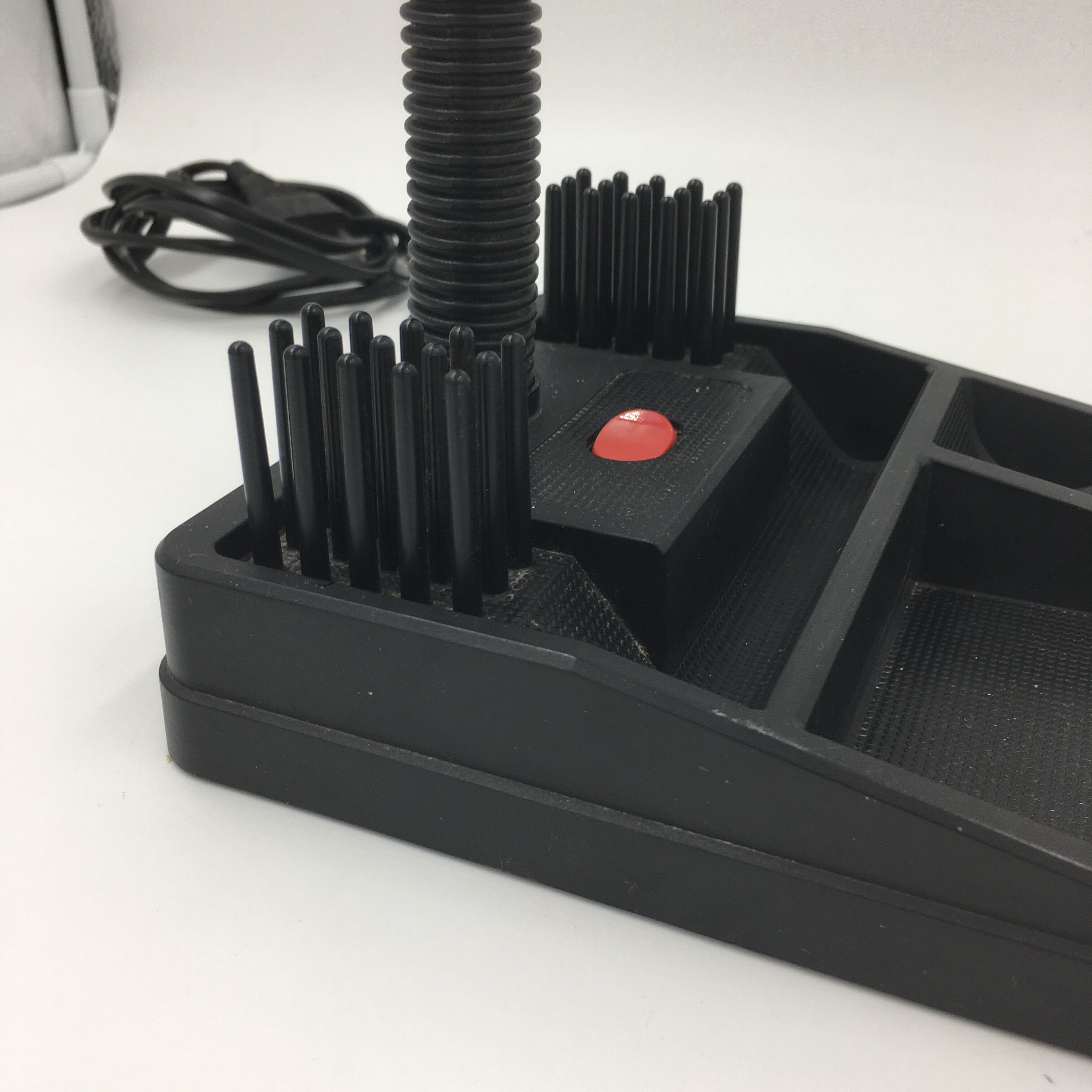 Duo of red and black flexible desk lamps with pencil holder