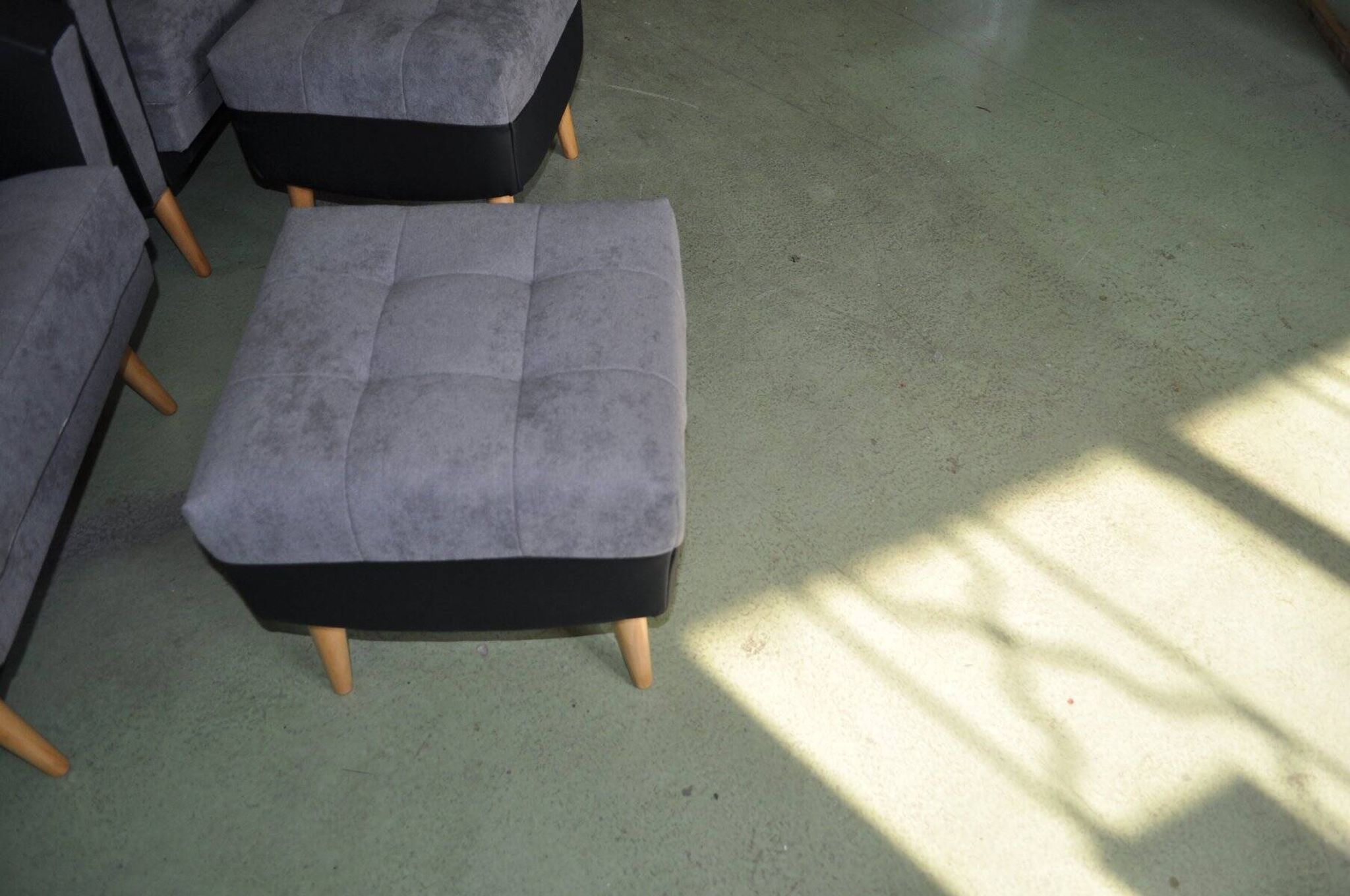 Set of 2 mid-century grey and black ottomans in fabric and eco-leather, wooden legs.