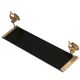 Wall shelf in gold metal and black glass adorned with fish.