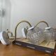 Large pair of brass swan neck wall lights with transparent glass globes.