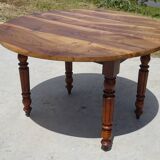 Round drop-leaf table made entirely of solid walnut